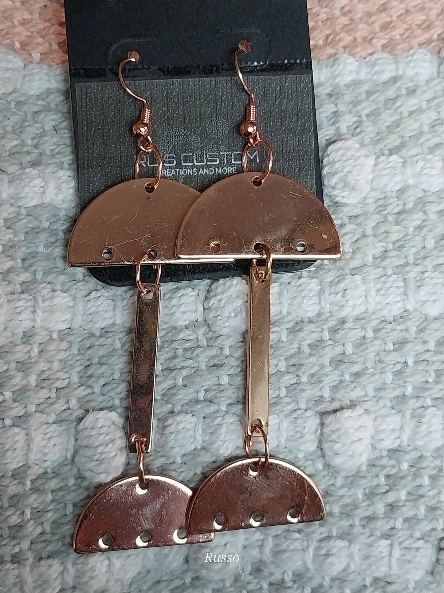 Rose gold colored eccentric earrings